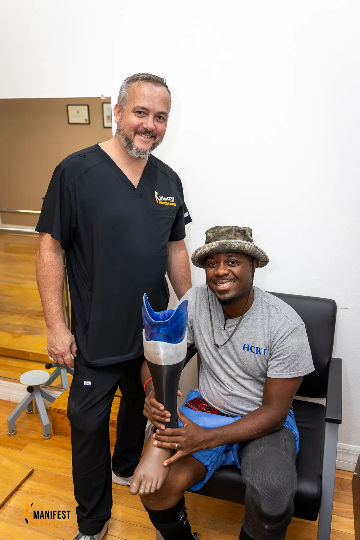 Robert Rollins with his Manifest clinician, holding his custom-painted prosthetic socket.